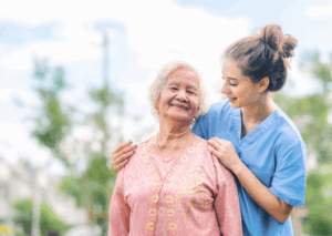Home care provider reviewing compliance documentation and care plans on a tablet during a client visit