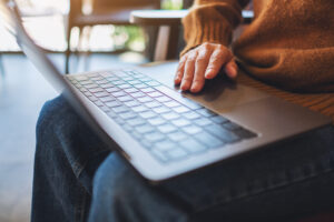 NDIS provider reviewing updated pricing schedule rates and service agreement on a laptop screen